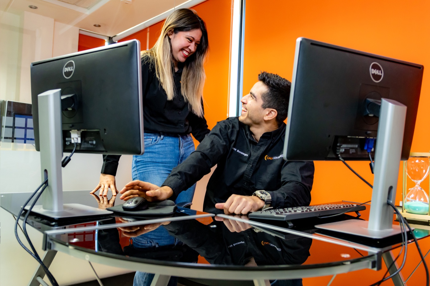CallCentered colleagues collaborating at a dual-monitor workstation in Hermosillo